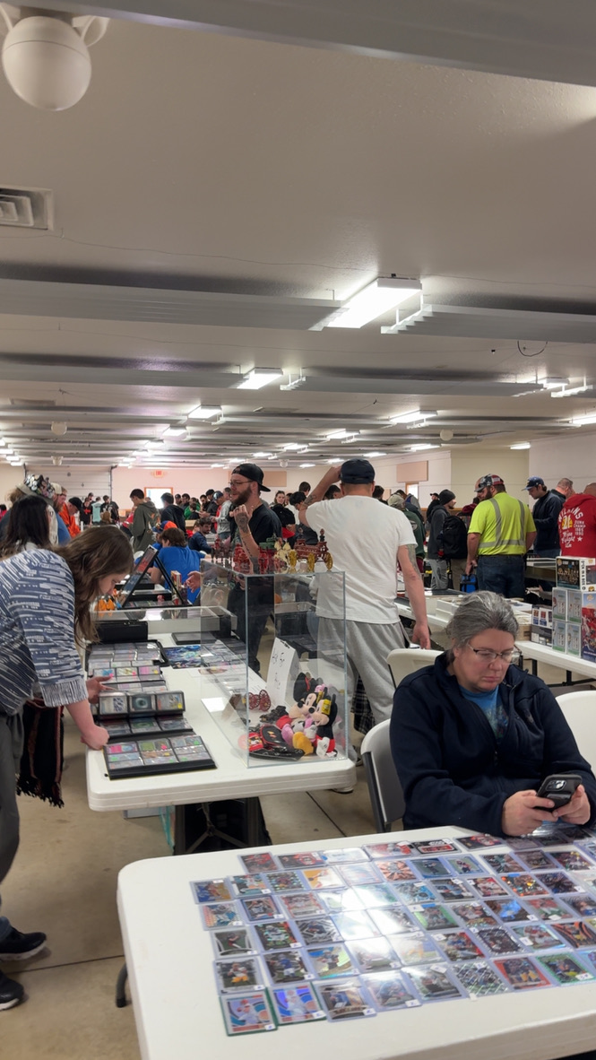 Collectors browsing card tables at a Dogtown show