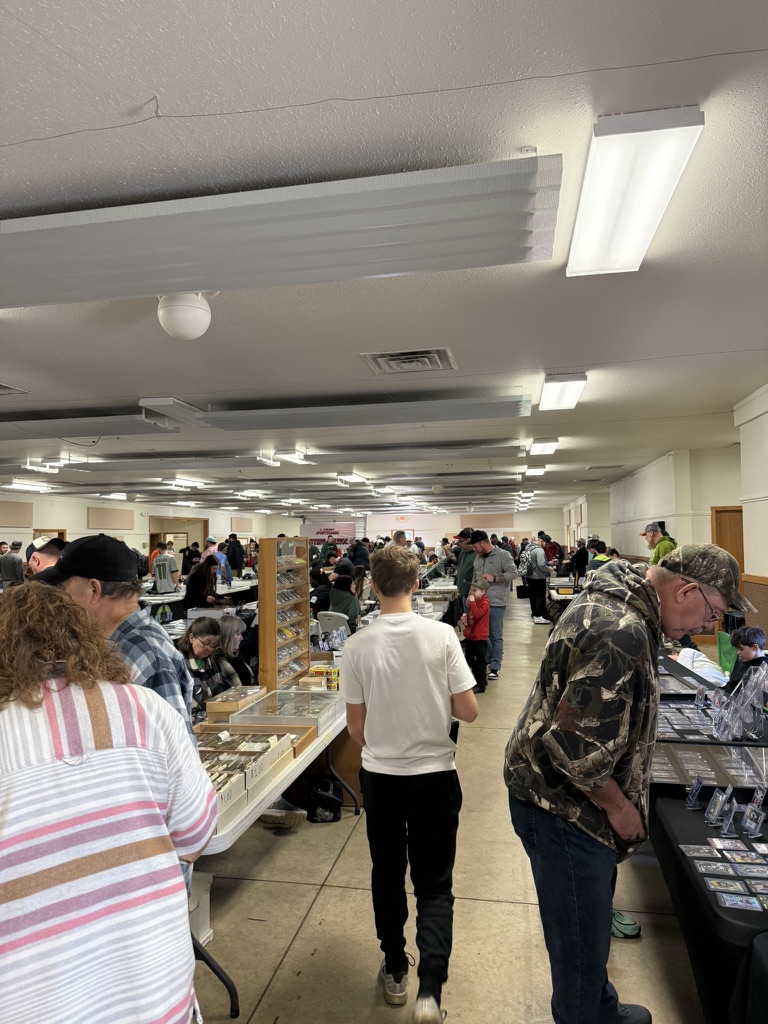 Collectors walking between rows of vendor tables